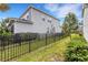 Landscaped side yard with black metal fence at 3431 Chestertown Loop, Bradenton, FL 34211