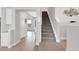 Modern staircase with gray carpeting and wood handrail at 3431 Chestertown Loop, Bradenton, FL 34211