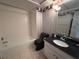 Bathroom with bathtub and dark vanity at 3725 Glen Oaks Manor Dr, Sarasota, FL 34232