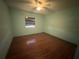 Bedroom with light walls and wood floor at 3725 Glen Oaks Manor Dr, Sarasota, FL 34232