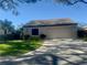 Front view of a villa with an attached garage and a well-maintained lawn at 3725 Glen Oaks Manor Dr, Sarasota, FL 34232