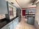 Kitchen with blue cabinets, stainless steel appliances, and a breakfast bar at 3725 Glen Oaks Manor Dr, Sarasota, FL 34232