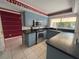 A galley-style kitchen with stainless steel appliances and blue cabinets at 3725 Glen Oaks Manor Dr, Sarasota, FL 34232