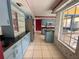 View of kitchen with blue cabinets, stainless steel appliances and a window at 3725 Glen Oaks Manor Dr, Sarasota, FL 34232