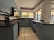 Full view of kitchen with light blue cabinets and stainless steel appliances at 3725 Glen Oaks Manor Dr, Sarasota, FL 34232