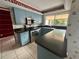 Light blue kitchen cabinets, stainless steel appliances, and dark countertops at 3725 Glen Oaks Manor Dr, Sarasota, FL 34232
