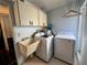 Laundry room with washer, dryer and cabinets at 3725 Glen Oaks Manor Dr, Sarasota, FL 34232