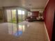Living area with tiled floors, garden view, and fireplace at 3725 Glen Oaks Manor Dr, Sarasota, FL 34232