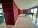 Open living area with tiled floors and burgundy walls at 3725 Glen Oaks Manor Dr, Sarasota, FL 34232