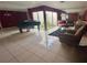 Living room with tiled floors, piano, and garden access at 3725 Glen Oaks Manor Dr, Sarasota, FL 34232