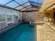 Enclosed pool and spa with painted mural at 3725 Glen Oaks Manor Dr, Sarasota, FL 34232