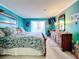 King-size bed in teal bedroom with balcony access at 3749 Lake Bayshore Dr # 303, Bradenton, FL 34205