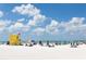 Beachfront view with lifeguard stand and many beachgoers at 4152 Central Sarasota Pkwy # 727, Sarasota, FL 34238