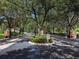 Gated entrance to Bella Villa Condominiums, lush landscaping, and a circular driveway at 4152 Central Sarasota Pkwy # 727, Sarasota, FL 34238