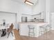 Modern kitchen with white cabinets, stainless steel appliances, and a breakfast bar at 4152 Central Sarasota Pkwy # 727, Sarasota, FL 34238