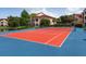 Well-maintained tennis court with red and blue surface at 4152 Central Sarasota Pkwy # 727, Sarasota, FL 34238