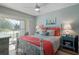 Bright bedroom with coral bedding, and sliding door to balcony at 431 Cerromar Ln # 446, Venice, FL 34293