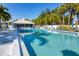 Inviting community pool with surrounding lounge chairs and cabana at 431 Cerromar Ln # 446, Venice, FL 34293