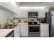 Modern kitchen with stainless steel appliances and white cabinets at 431 Cerromar Ln # 446, Venice, FL 34293