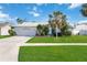 Single-story home with a two-car garage and landscaped lawn at 4531 Topaz Ct, Sarasota, FL 34233