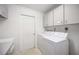 Laundry room with washer, dryer, and cabinets at 4531 Topaz Ct, Sarasota, FL 34233