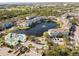 Aerial view showing community pool, lake, and multiple residential buildings at 4802 51St W St # 501, Bradenton, FL 34210