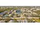 Aerial view of a community with lake, tennis courts, and numerous buildings at 4802 51St W St # 501, Bradenton, FL 34210