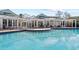 Community pool with pergola and seating at 4802 51St W St # 501, Bradenton, FL 34210