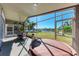 Screened porch with hot tub, table, and lake view at 4861 Sabal Harbour Dr, Bradenton, FL 34203