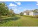 Landscaped backyard with pond view and lush green grass at 5213 Asher Ct, Sarasota, FL 34232