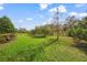 Large backyard with grassy area and mature trees at 5213 Asher Ct, Sarasota, FL 34232