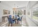 Bright dining room with table and chairs, and large windows at 5213 Asher Ct, Sarasota, FL 34232