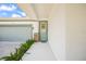 Front entry with teal door, stone accents and lush ferns at 5213 Asher Ct, Sarasota, FL 34232