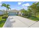 Single-story house with teal garage door, stone accents, and lush landscaping at 5213 Asher Ct, Sarasota, FL 34232