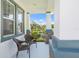 Relaxing front porch with wicker chairs and a view of the water at 5213 Asher Ct, Sarasota, FL 34232