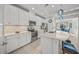 Modern kitchen with white cabinets, stainless steel appliances, and island at 5213 Asher Ct, Sarasota, FL 34232