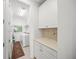 Laundry room with washer, dryer, cabinets, and built-in counter space at 5213 Asher Ct, Sarasota, FL 34232