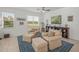 Bright sitting room with two armchairs, ottomans, and built-in shelving at 5213 Asher Ct, Sarasota, FL 34232