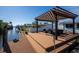 Spacious canal-front dock with pergola and seating area at 524 Palm Ave, Ellenton, FL 34222