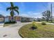 Single story home with circular driveway and palm trees at 524 Palm Ave, Ellenton, FL 34222