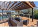 Relaxing deck with pergola, fire pit, and water views at 524 Palm Ave, Ellenton, FL 34222