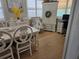 Bright dining room with a charming table and white chairs at 550 80Th Ave, St Pete Beach, FL 33706