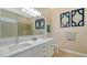 Elegant bathroom with double vanity, quartz countertops, and a large walk-in shower at 5632 Fossano Dr, Sarasota, FL 34238