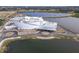 Aerial view of a modern building under construction near a lake at 5697 Sheffield Greene Cir # 51, Sarasota, FL 34235