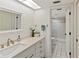 Clean bathroom with updated vanity, large mirror, and shower at 5697 Sheffield Greene Cir # 51, Sarasota, FL 34235
