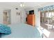 Bright bedroom with a comfortable bed, dresser, and access to a private patio at 5697 Sheffield Greene Cir # 51, Sarasota, FL 34235