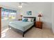 King-size bed, wood nightstands and access to patio at 5697 Sheffield Greene Cir # 51, Sarasota, FL 34235