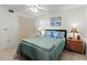 Bedroom with queen-size bed, nightstands and ceiling fan at 5697 Sheffield Greene Cir # 51, Sarasota, FL 34235