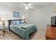 Bedroom with a queen-size bed, nightstands and ceiling fan at 5697 Sheffield Greene Cir # 51, Sarasota, FL 34235