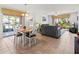 Combined living and dining area with gray sofa and wooden table at 5697 Sheffield Greene Cir # 51, Sarasota, FL 34235